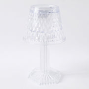 Modern LED crystal lamp displayed on a wooden shelf in a home setting.