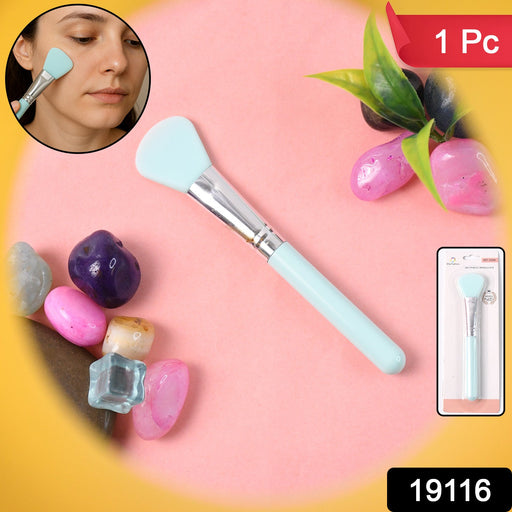 Silicone brush gently applying cream mask on skin with plastic handle