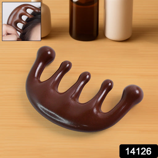 Manual scalp massager comb being used for headache relief