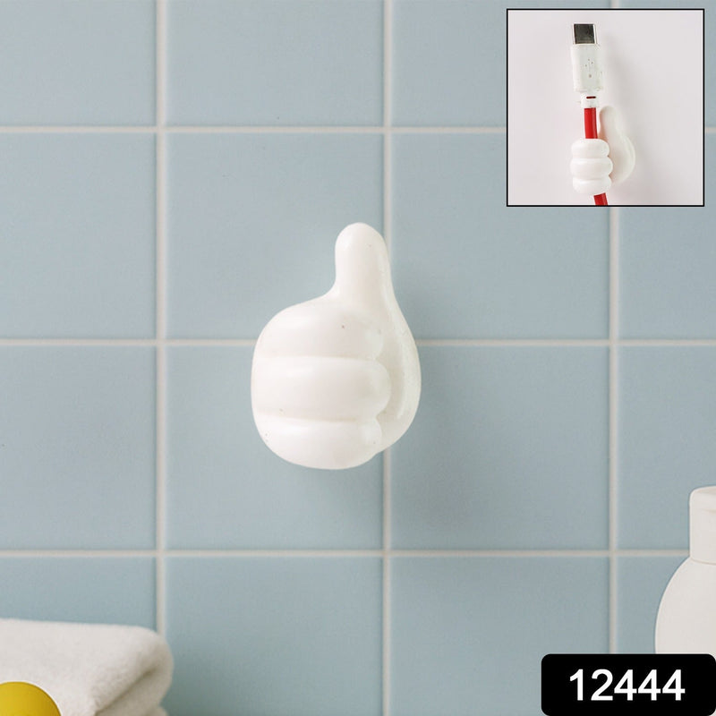 Close-up view of white palm-shaped multifunctional cable clip on wall