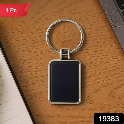 Black and silver rectangular metal keychain featuring metro stripe design