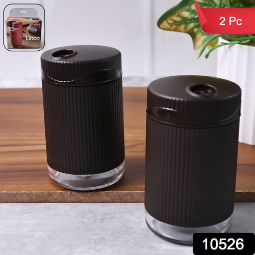 Two-piece salt and pepper shaker set with rotating lids for controlled seasoning
