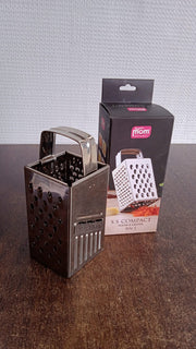 Supermom 4-in-1 stainless steel grater displayed in a home kitchen setup