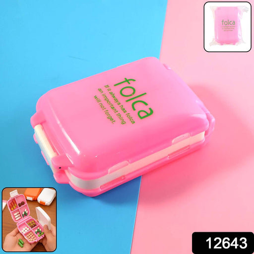 Open pink pill box showing dual-sided compartments for pills