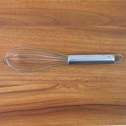 Small stainless steel balloon whisk on white background