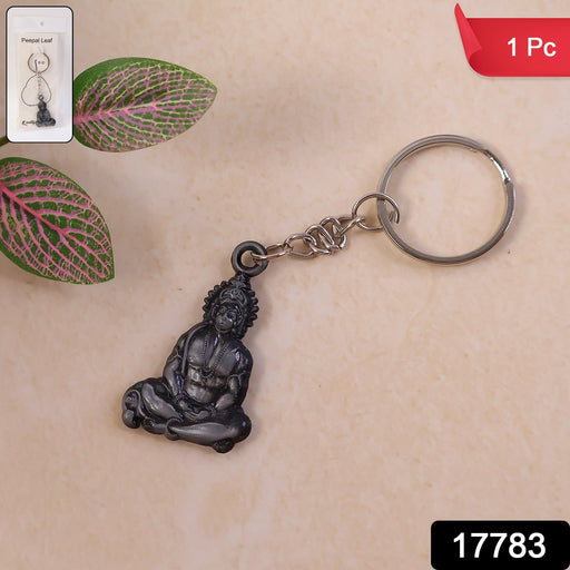 Close-up of Hanuman Ji sitting pose idol on metal keychain