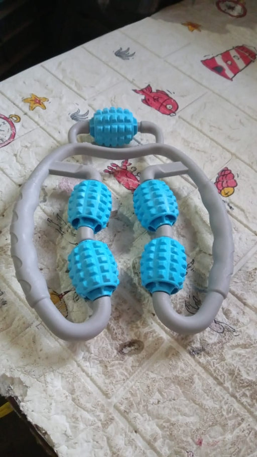 The muscle massage roller in action, targeting a user's arm for muscle relaxation.