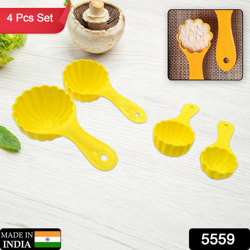 A hand uses a plastic ladoo mould spoon to create a perfectly round traditional sweet.