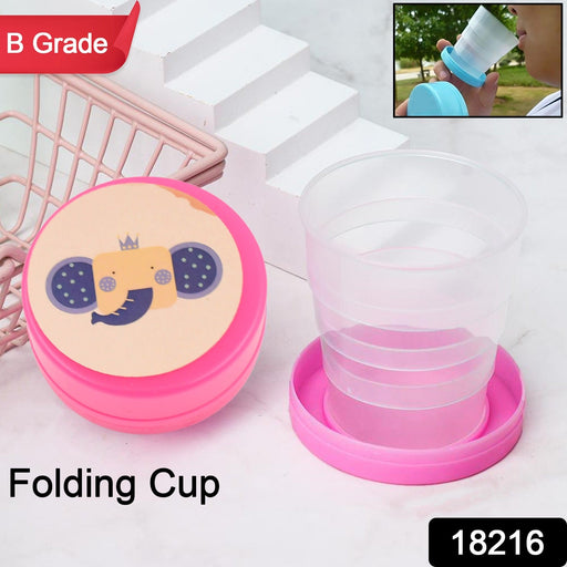 The compact green folding travel cup, shown in its fully collapsed state.