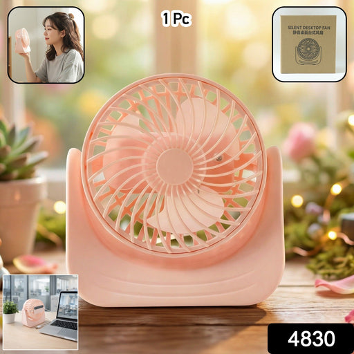 Compact silent mini desk fan placed on a wooden office desk