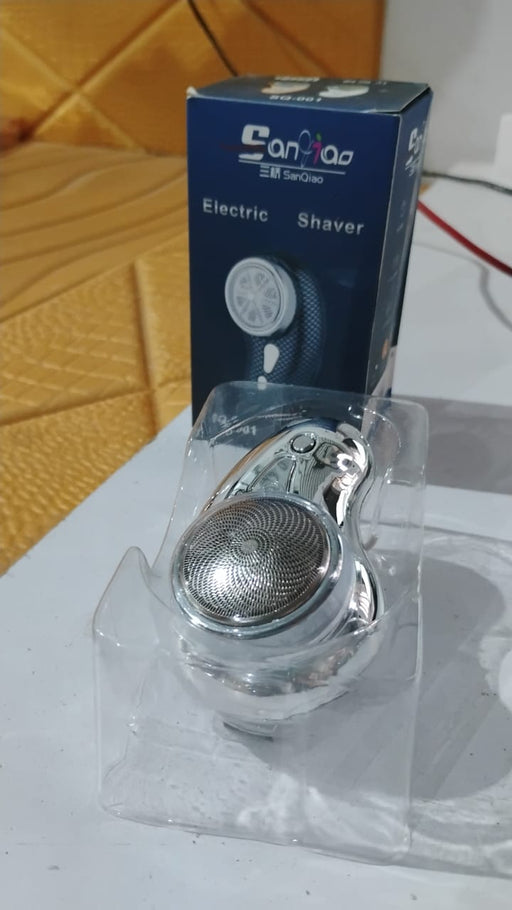 Close-up component view of portable electric shaver blades and cutter head