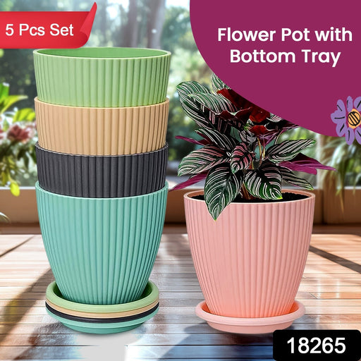 Five black plastic flower pots arranged together, perfect for home gardening and decor.