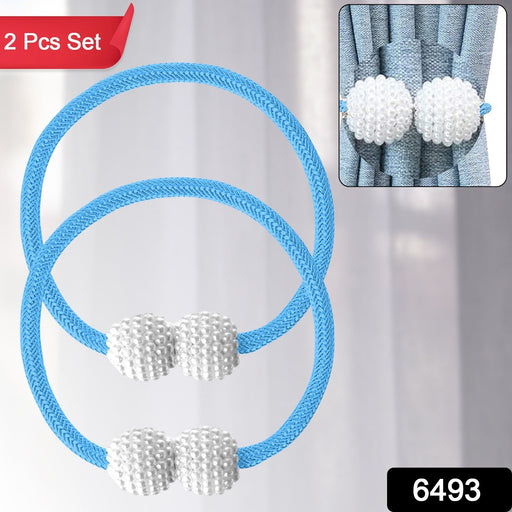 Close-up of magnetic curtain tieback on a sheer curtain showing braided polyester band