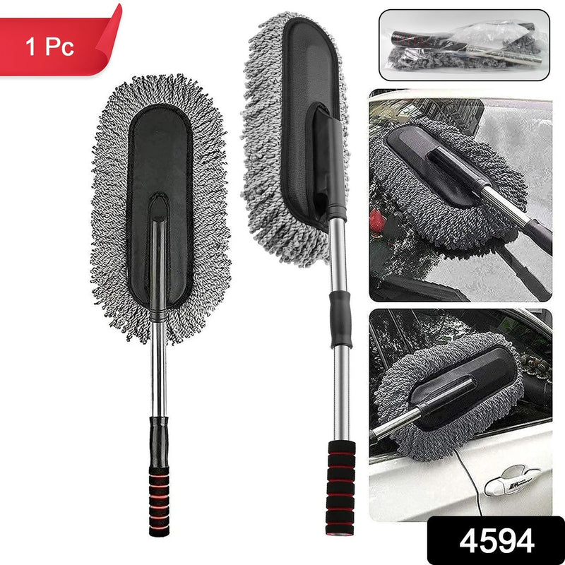 Hand using the soft Car Dust Brush to meticulously clean a car's dashboard without scratching surfaces.