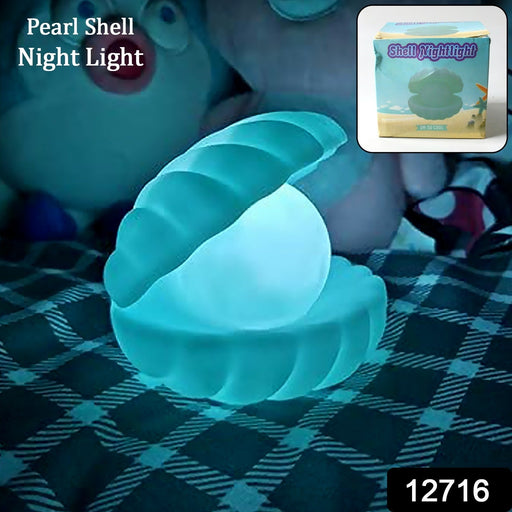 A close-up of the Pearl Shell Night Lamp illuminating a dark room with a soft, warm glow.