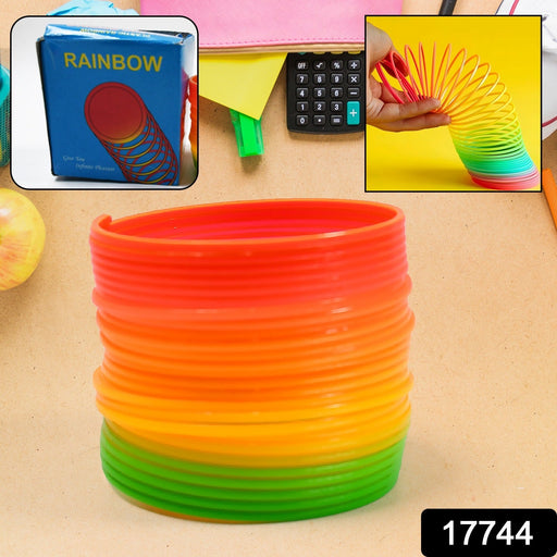 A child happily playing with the Rainbow Slinky Toy, demonstrating its fun movement.