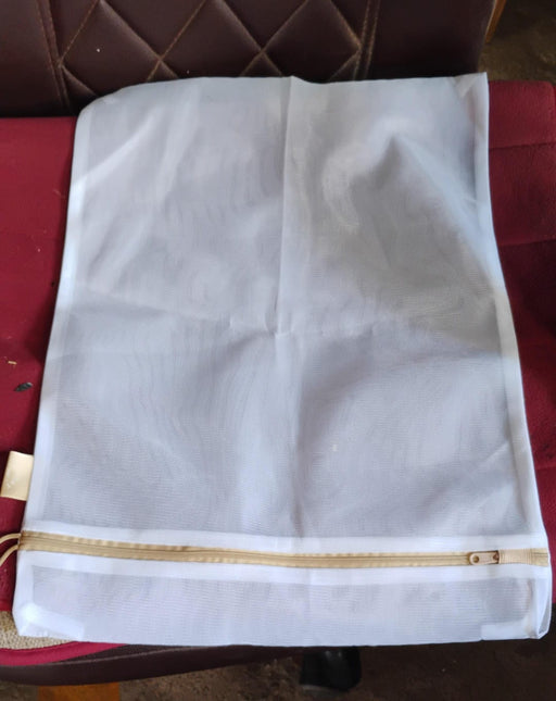 Keeping laundry organised and protecting clothes with a mesh delicates bag.