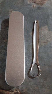 Packaging for the MintGuard stainless steel tongue scraper.