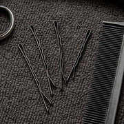 Detailed close-up of black bobby pin with smooth tips