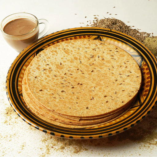 Round, thin Jeera Khakhra pieces arranged, highlighting their crispy texture.
