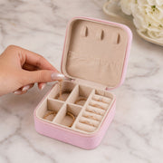 A closed LilyGleam Mini PU Leather Travel Jewellery Box in a stylish pink shade, perfect for organising accessories.
