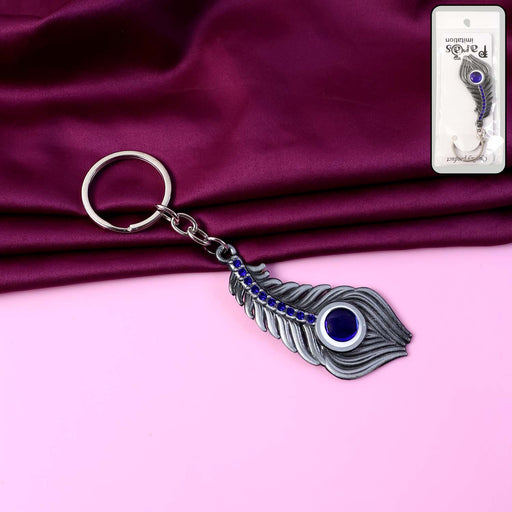 Elegant metal peacock feather keychain featuring blue gem accent