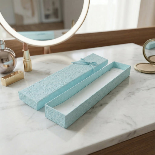 Long rectangular jewelry box with decorative ribbon closure and soft interior
