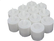 Several LED tealight candles illuminating a dark setting, showing their warm glow.