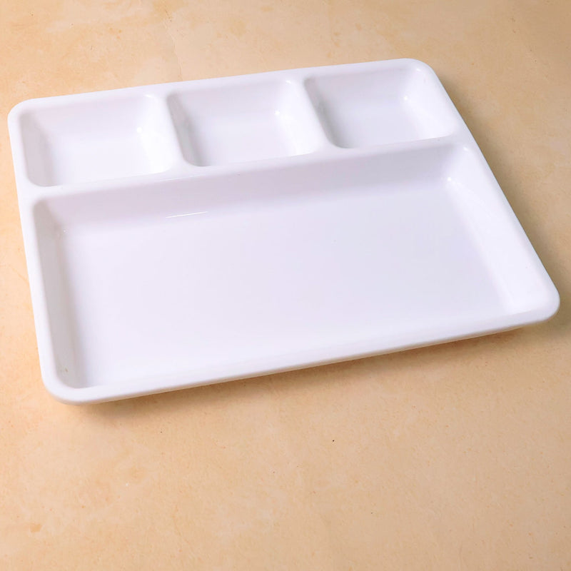Empty 4-section plastic tray ready for meal preparation or serving.