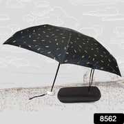 Comparison shot of the folded compact umbrella with a small water bottle, emphasizing its travel-friendly size.