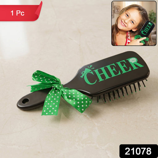 Cute printed kids hair brush featuring a ribbon bow handle, ideal for daily grooming.