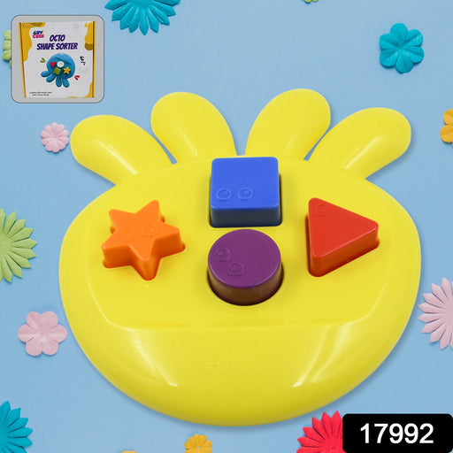Colorful geometric shapes from the Octo Shape Sorter Toy neatly laid out on a surface.