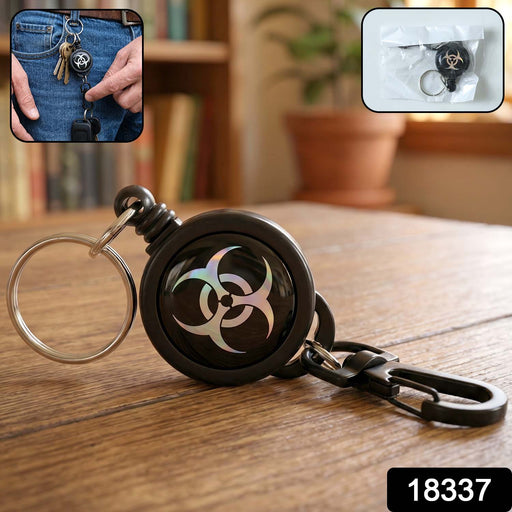 Close-up of retractable keychain clip holding a set of keys.