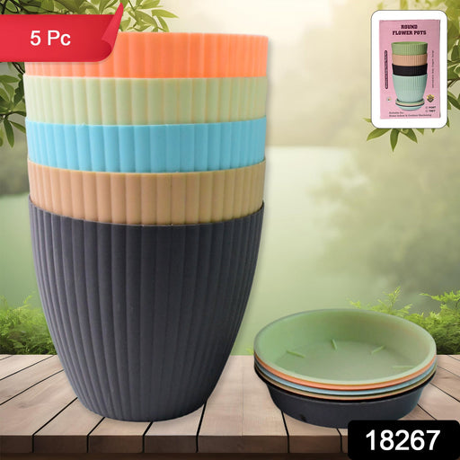 Close-up view of a matte finish round plastic flower pot with subtle stripe details.