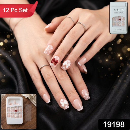 Complete set of 26 glitter floral press-on nail tips neatly arranged in packaging with nail glue pen.