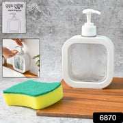Refillable clear soap dispenser placed on a modern bathroom vanity with a faucet.